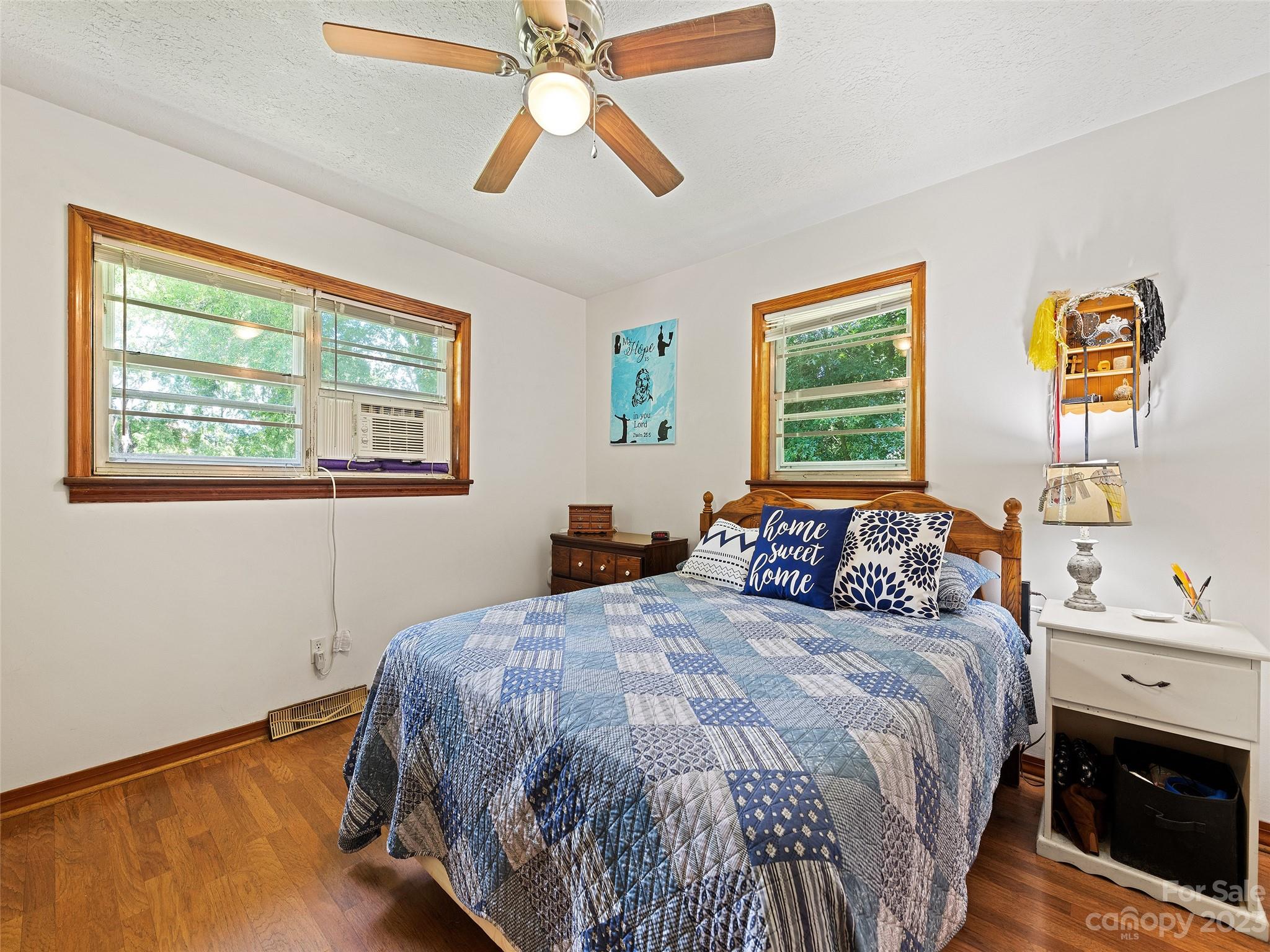 52 Walnut Road Clyde, NC 28721 - Photo 16 of 25 a bedroom with a bed and a chandelier
