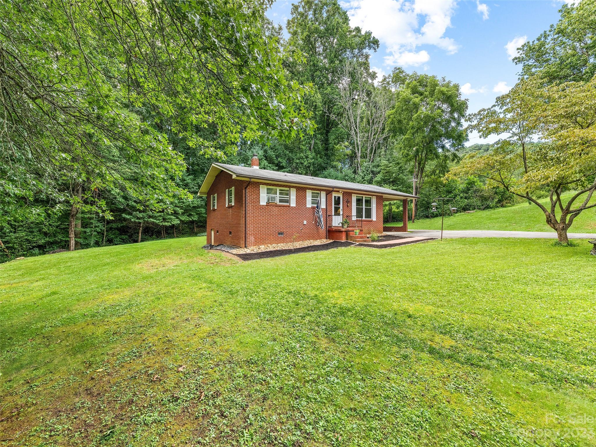 52 Walnut Road Clyde, NC 28721 - Photo 4 of 25 a view of a house with a backyard