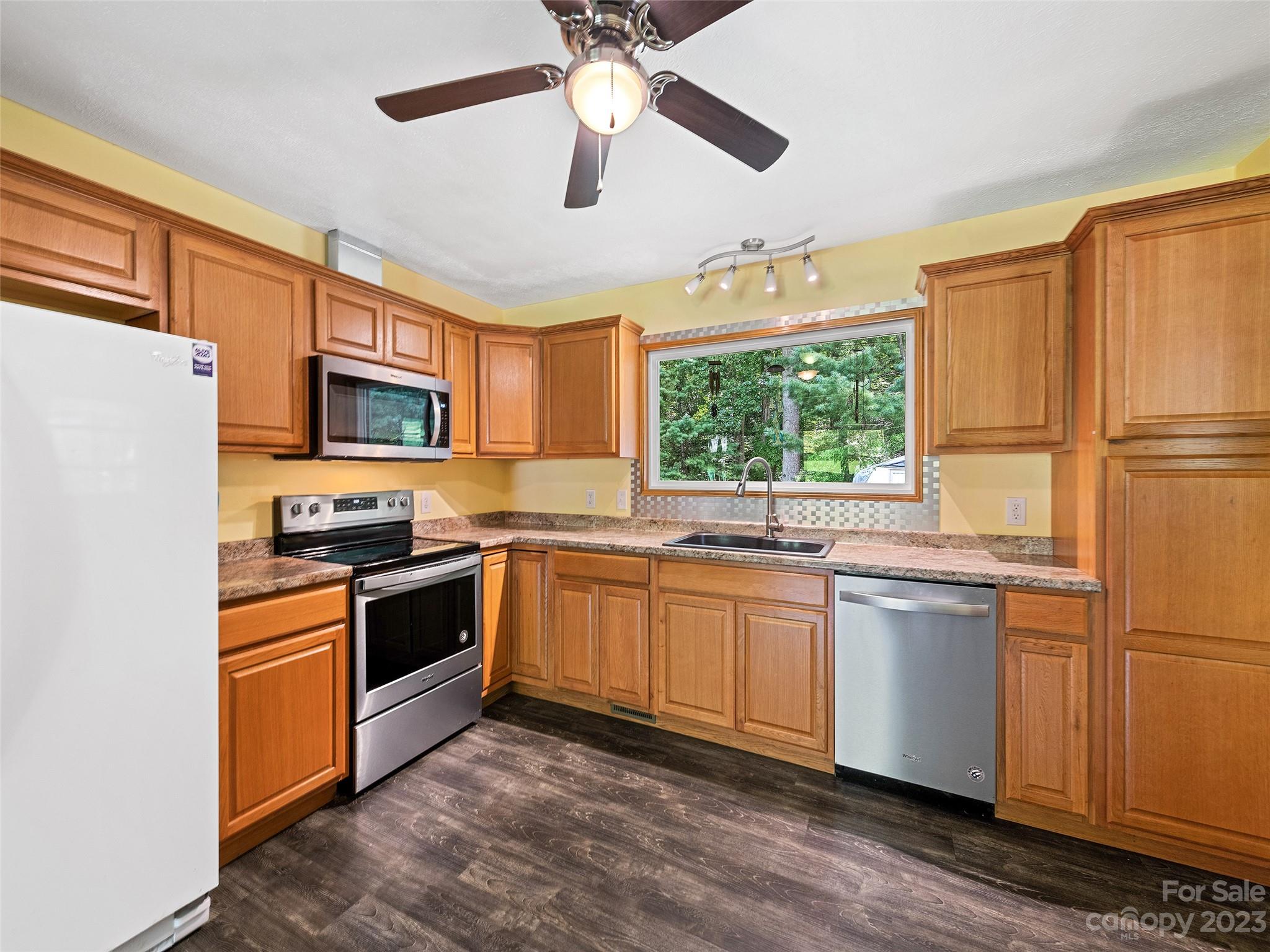 52 Walnut Road Clyde, NC 28721 - Photo 9 of 25 a kitchen with stainless steel appliances granite countertop a refrigerator a stove a sink and a microwave