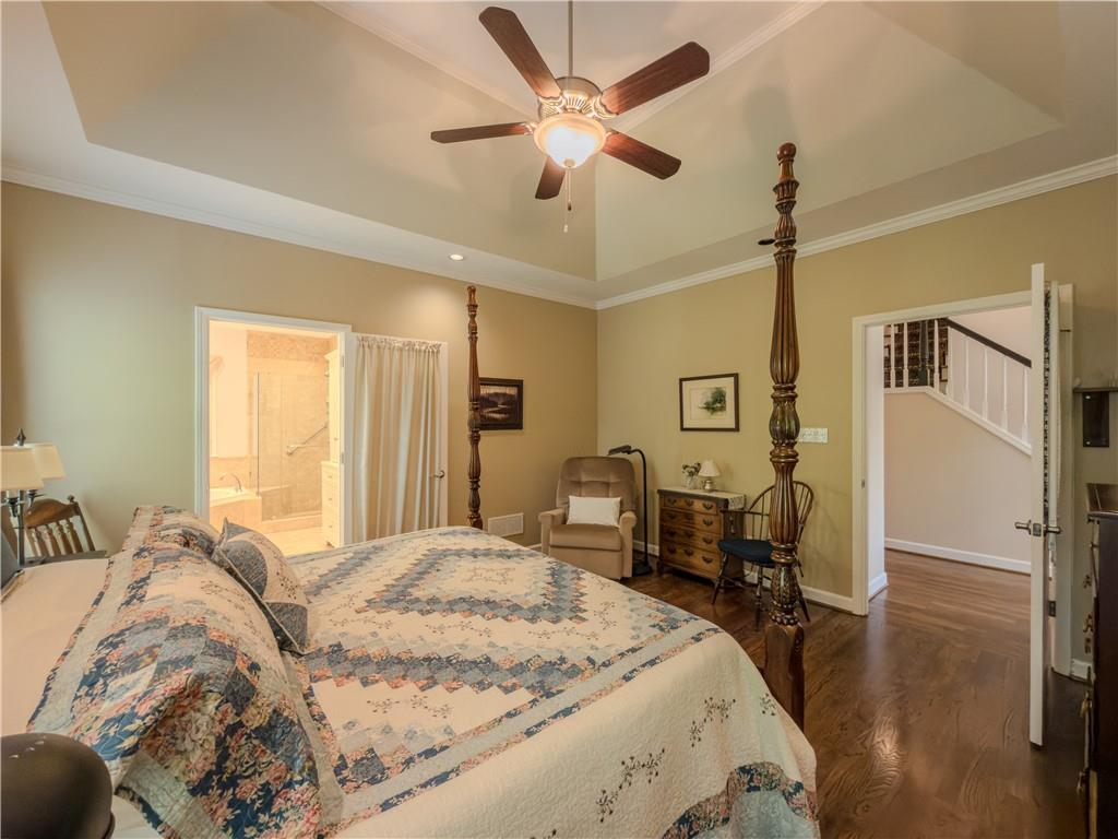 4284 Cedar Bluff Way Southwest Lilburn, GA 30047 - Photo 12 of 62 a bedroom with a bed and a table with the potted plant