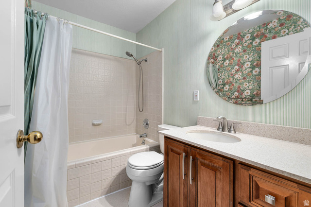 1822 East 9800th Street South Sandy, UT 84092 - Photo 33 of 38 Full bathroom with wallpapered walls, vanity, and shower / bath combo with shower curtain