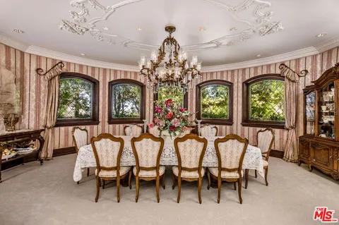 a view of a dining room with furniture and a chandelier