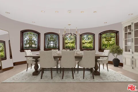 a view of a dining room with furniture and windows