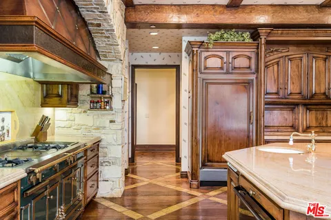a kitchen with a stove and a refrigerator