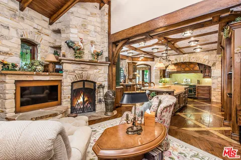 a living room with fireplace furniture and a fireplace