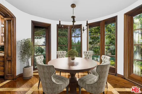a dining room with furniture wooden floor and a potted plant