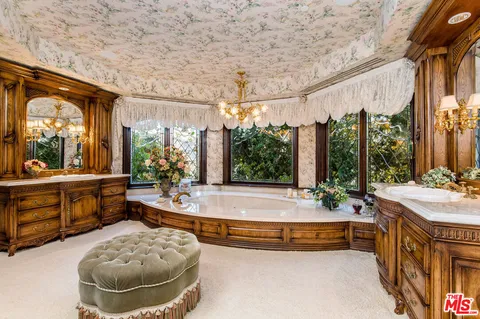 a spacious bedroom with a bed and a large window