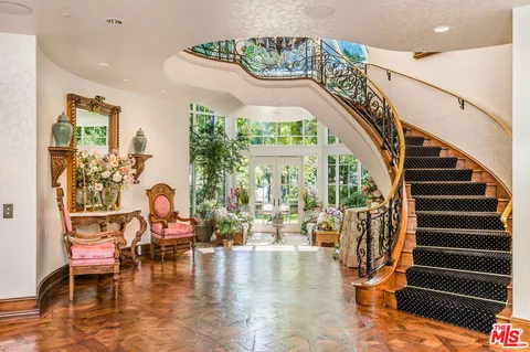 a view of entryway and hall with wooden floor