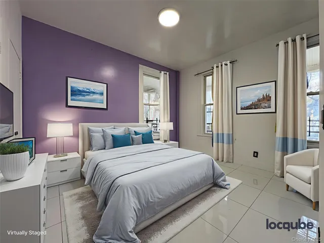 a bedroom with a bed and a couch