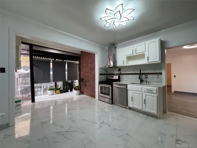 a kitchen with a stove a sink and cabinets