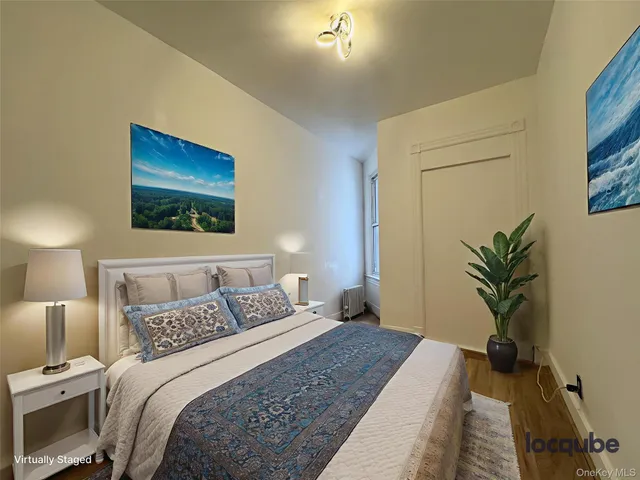 a bedroom with a bed and a potted plant