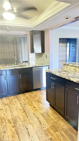 a kitchen with granite countertop a sink and cabinets