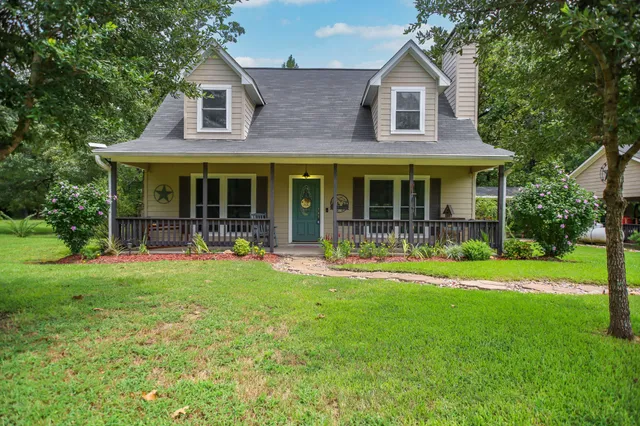 a front view of a house with a garden and porch