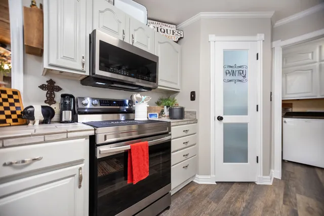 a kitchen with stainless steel appliances a stove a microwave and cabinets