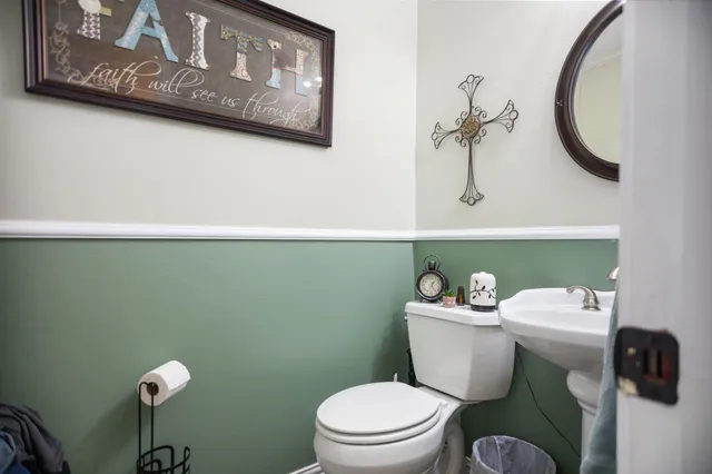 a white toilet sitting next to a bathroom sink