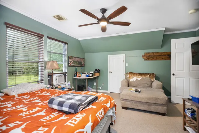 a bedroom with a bed and window