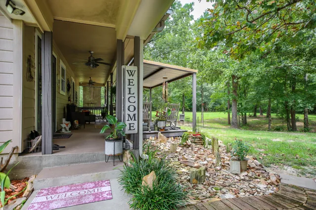a view of a porch with furniture and garden