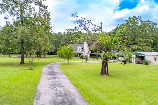 a view of a house with a backyard