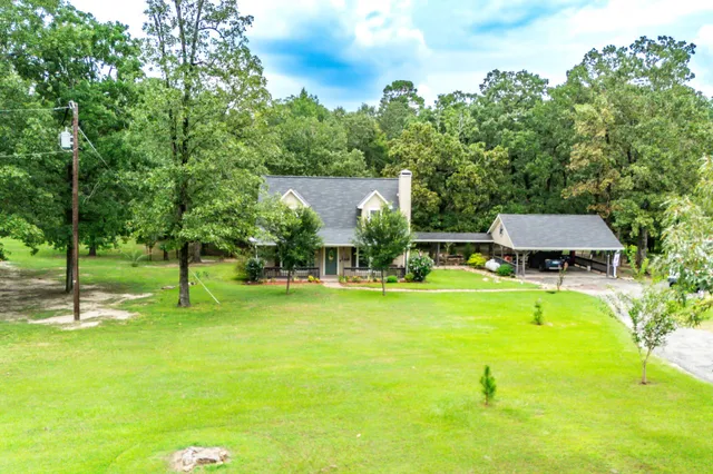an aerial view of a house with a garden and swimming pool