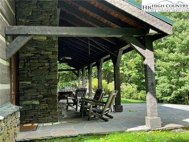 a view of a patio with table and chairs under an umbrella