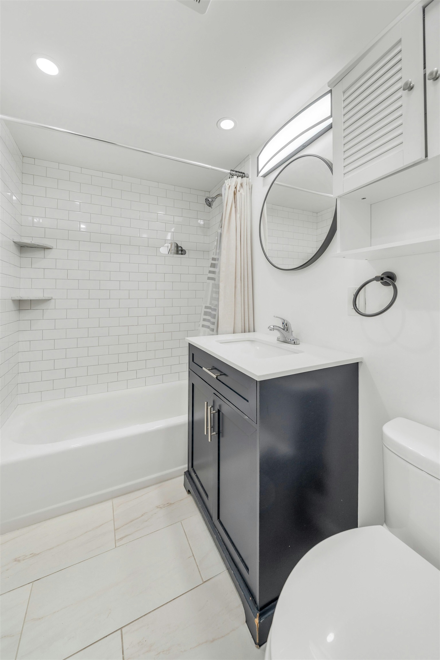 722 27th Street, Unit G Union City, NJ 07087 - Photo 14 of 25 a bathroom with a double vanity sink toilet mirror and bathtub