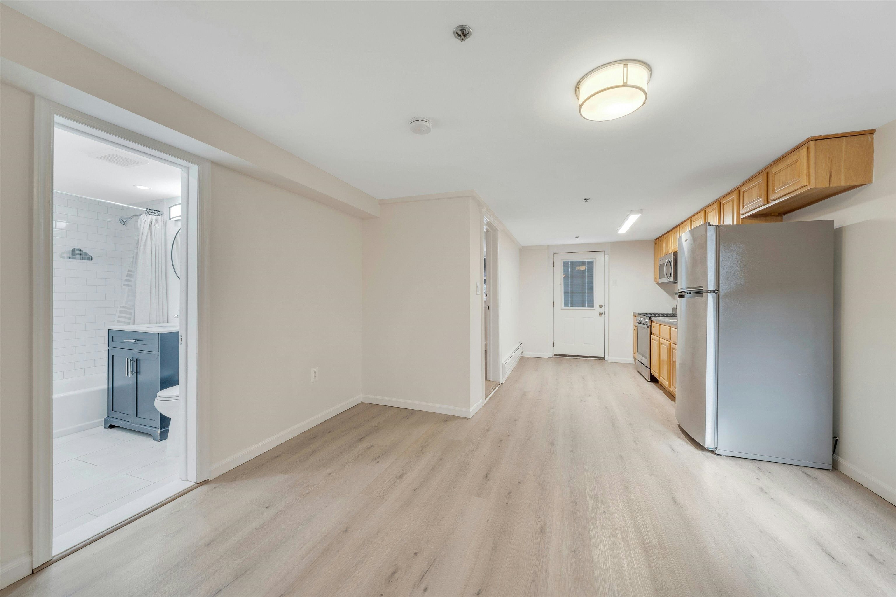 722 27th Street, Unit G Union City, NJ 07087 - Photo 2 of 25 a view of a hallway with wooden floor and a bathroom