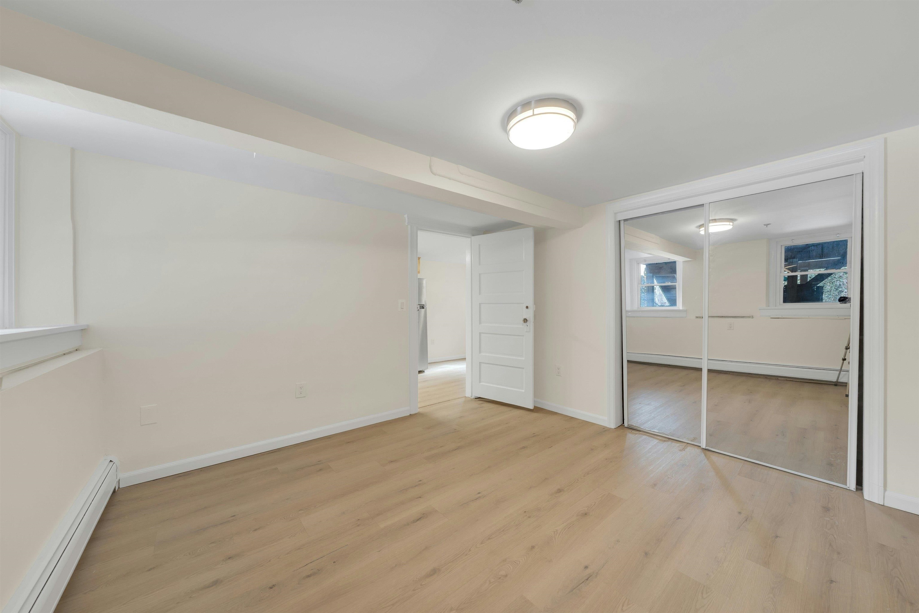 722 27th Street, Unit G Union City, NJ 07087 - Photo 10 of 25 wooden floor in an empty room