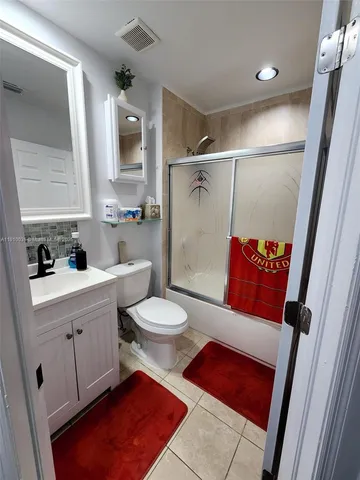 a bathroom with a toilet sink and shower
