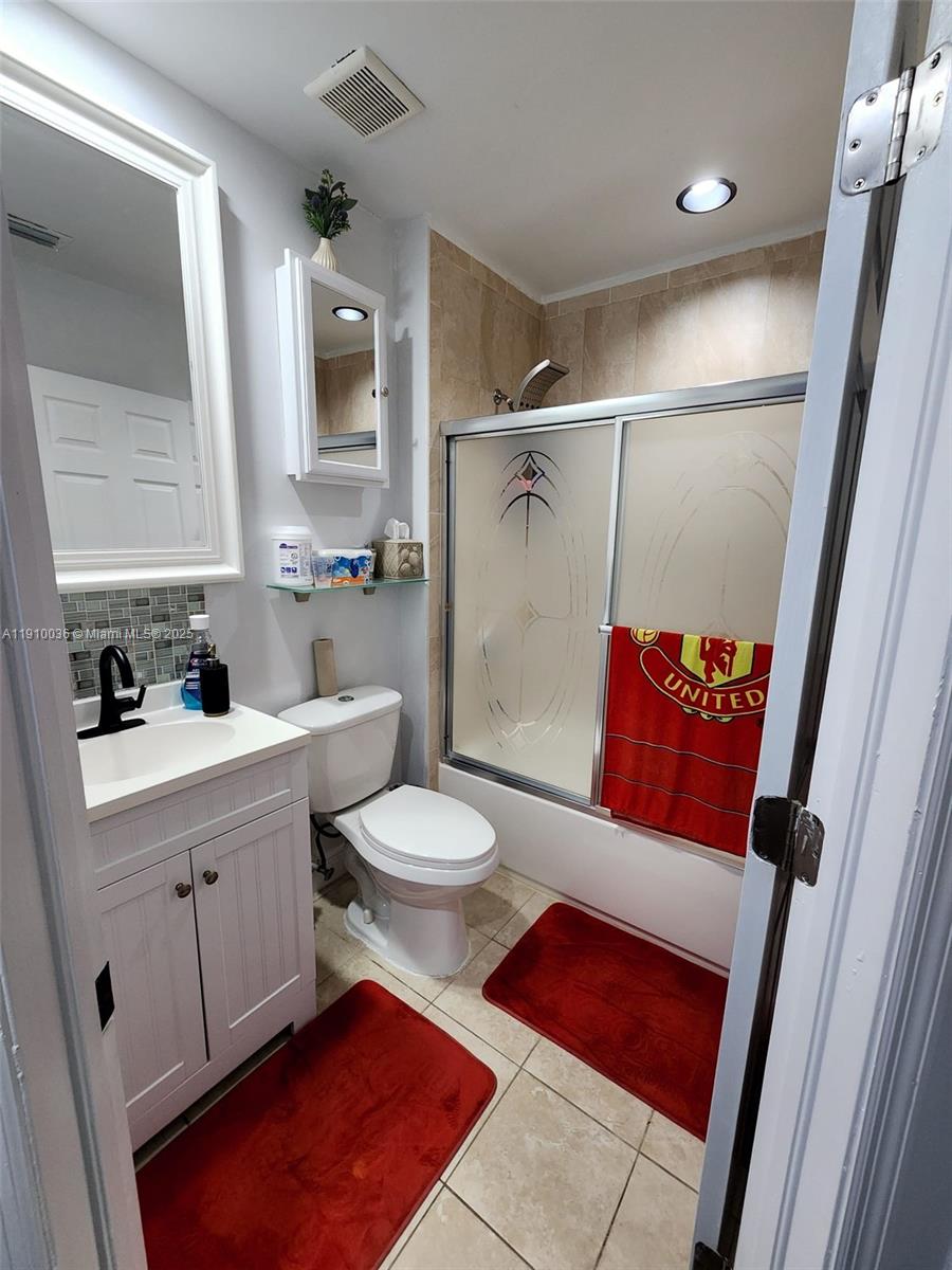 12430 Southwest 50th Street, Unit 147 Miramar, FL 33027 - Photo 11 of 14 a bathroom with a toilet sink and shower