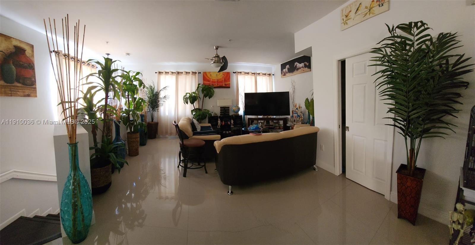 12430 Southwest 50th Street, Unit 147 Miramar, FL 33027 - Photo 6 of 14 a living room with furniture and a flat screen tv