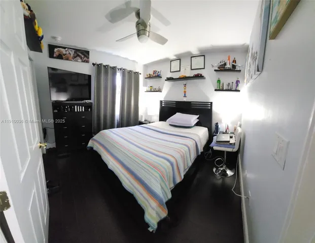 a bedroom with a bed and a television