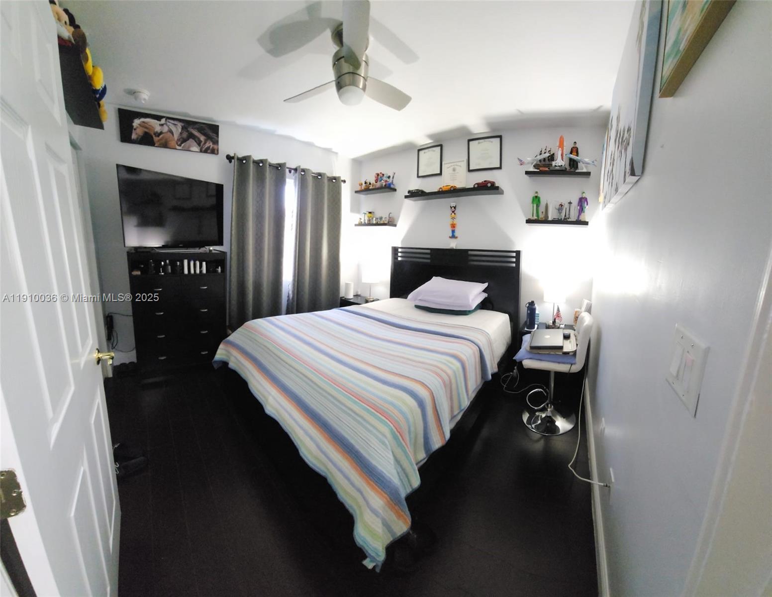 12430 Southwest 50th Street, Unit 147 Miramar, FL 33027 - Photo 9 of 14 a bedroom with a bed and a television