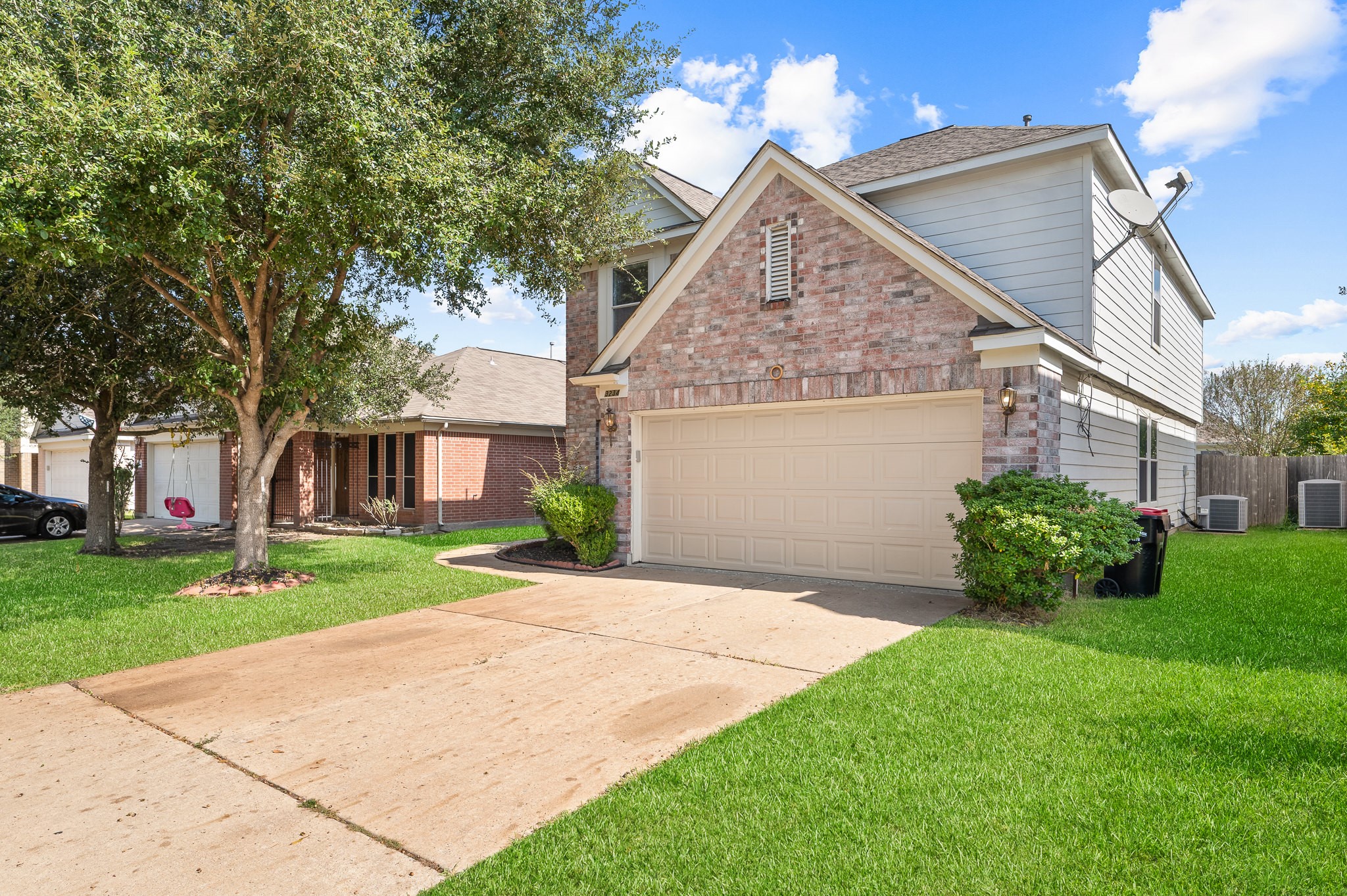 a front view of a house with a yard and trees