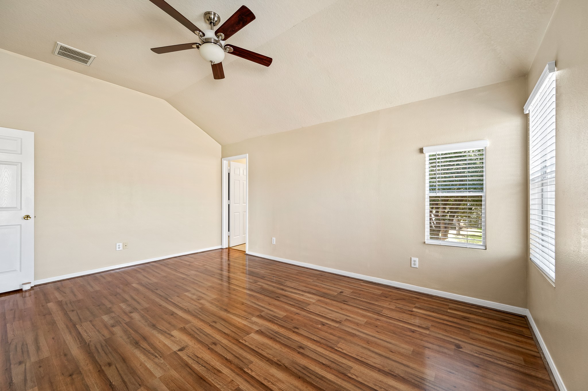 3234 Clipper Winds Way Houston, TX 77084 - Photo 35 of 46 an empty room with wooden floor fan and windows