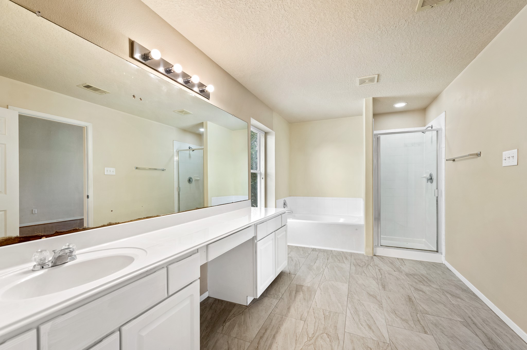 3234 Clipper Winds Way Houston, TX 77084 - Photo 36 of 46 a spacious bathroom with a double vanity sink a mirror and a bathtub