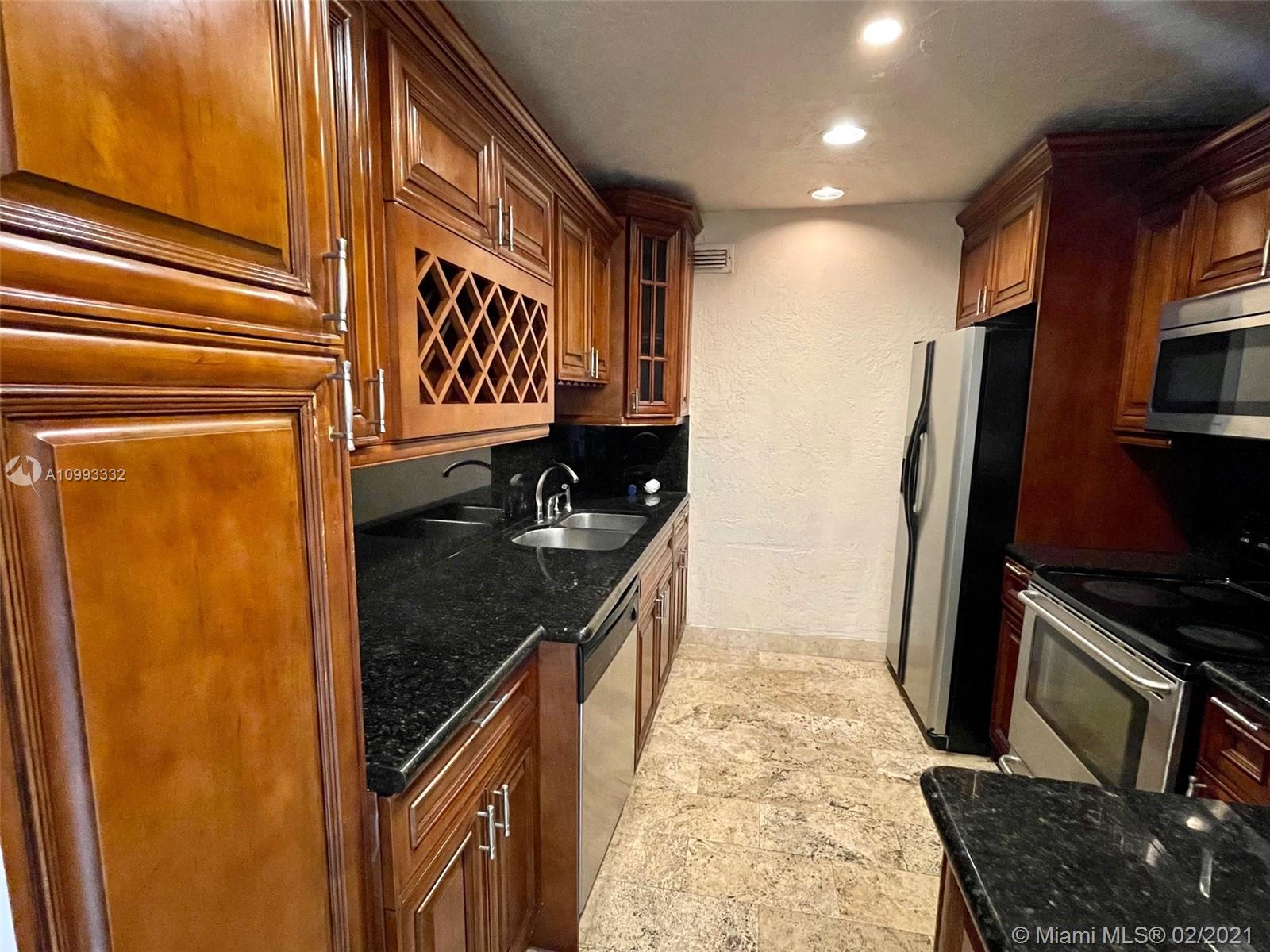 2008 Jackson Street, Unit C7 Hollywood, FL 33020 - Photo 1 of 24 a kitchen with stainless steel appliances granite countertop a stove a sink and a refrigerator
