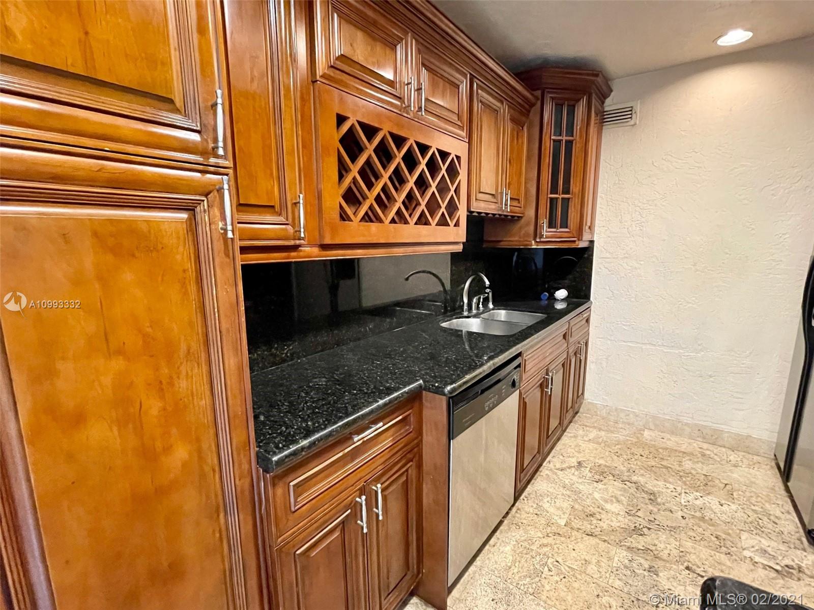 2008 Jackson Street, Unit C7 Hollywood, FL 33020 - Photo 2 of 24 a kitchen with a sink and a refrigerator