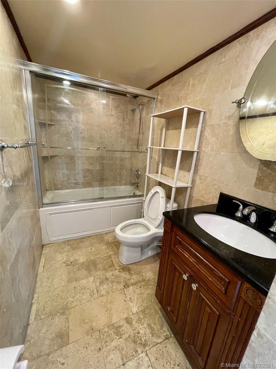2008 Jackson Street, Unit C7 Hollywood, FL 33020 - Photo 11 of 24 a bathroom with a sink and a mirror