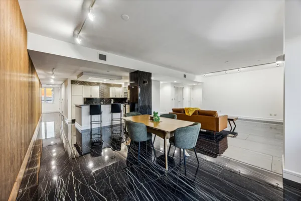 a dining room with furniture and wooden floor