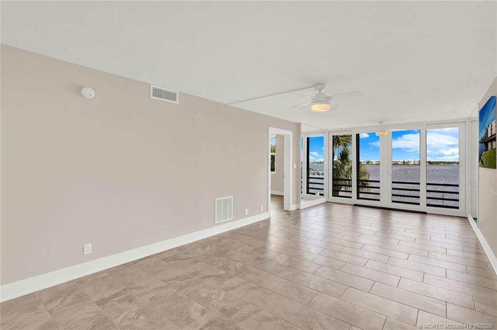 1950 Southwest Palm City Road, Unit 14305 Stuart, FL 34994 - Photo 13 of 70 wooden floor in an empty room with a window