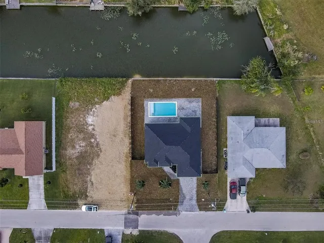 an aerial view of residential houses with outdoor space
