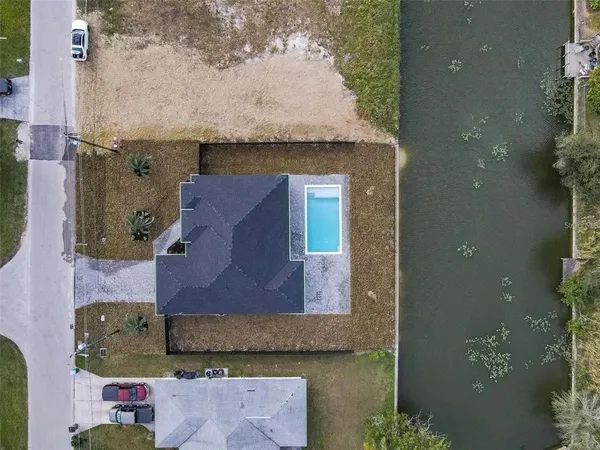 an aerial view of a house with a yard