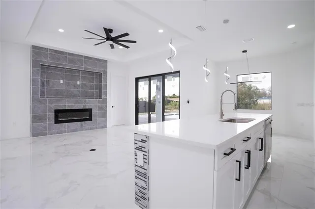 a kitchen with stainless steel appliances kitchen island granite countertop a stove a sink and a refrigerator