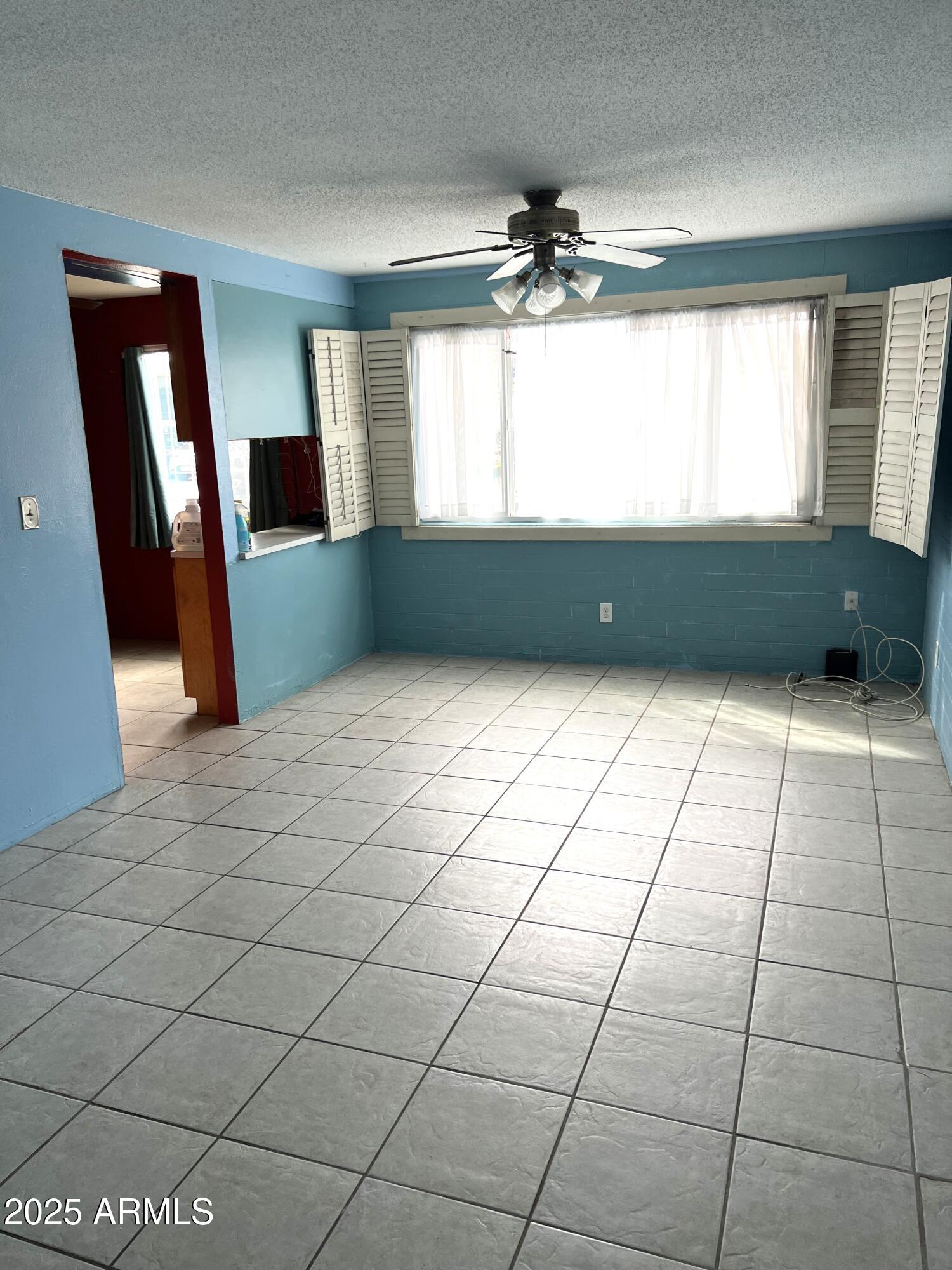 2530 West Berridge Lane, Unit E102 Phoenix, AZ 85017 - Photo 7 of 15 a view of an empty room with a window