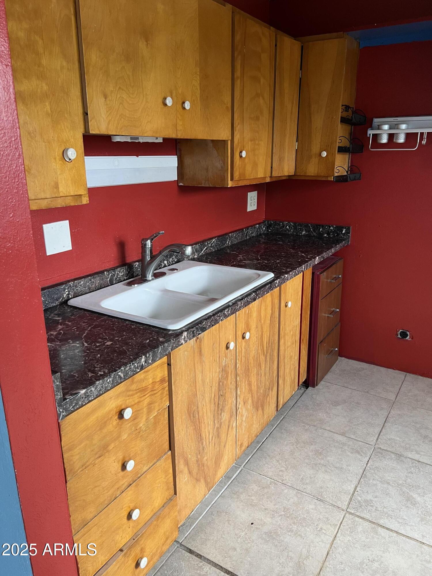 2530 West Berridge Lane, Unit E102 Phoenix, AZ 85017 - Photo 9 of 15 a kitchen with stainless steel appliances granite countertop a sink and a stove