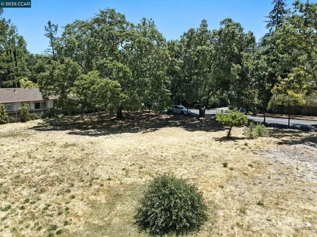 a view of a yard with snow on the road