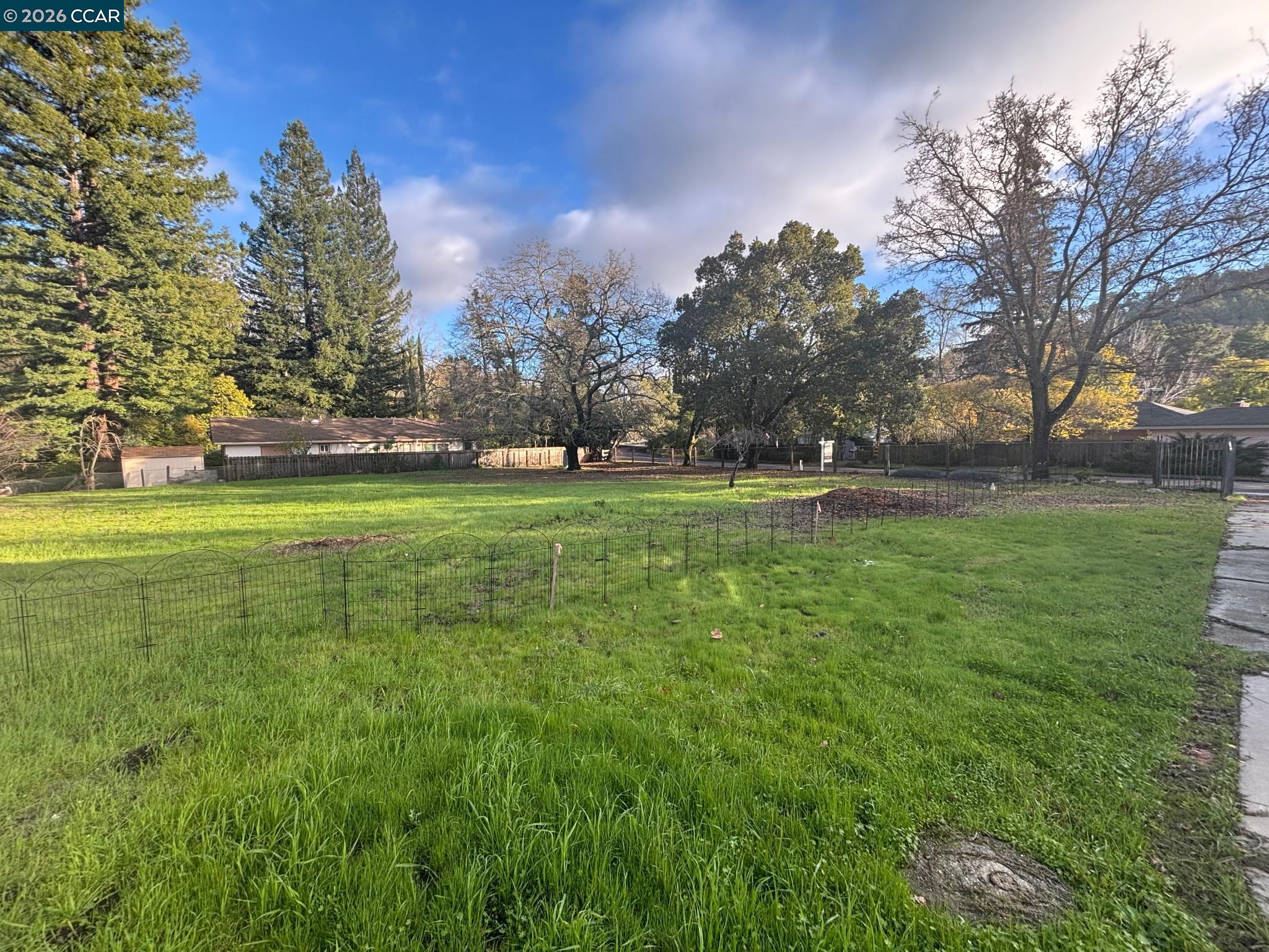 3894 El Nido Ranch Road Lafayette, CA 94549 - Photo 19 of 22 a backyard of a house with lots of green space and fountain