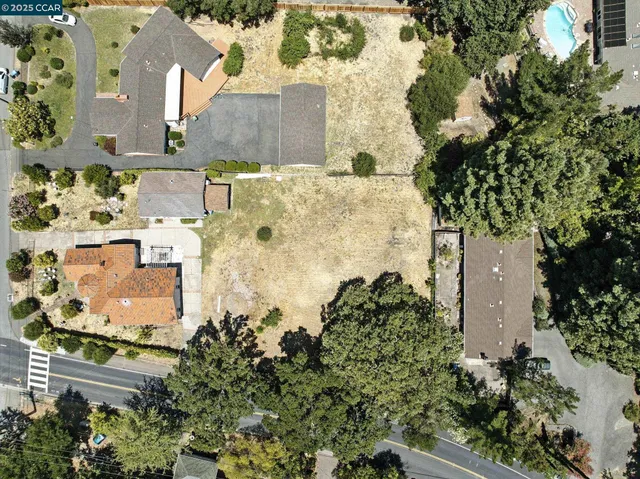 an aerial view of a house with a yard