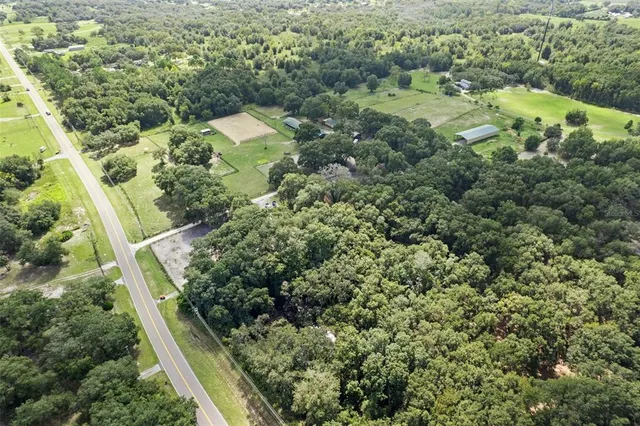 an aerial view of a house with a yard