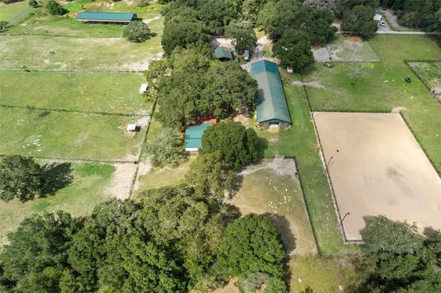 an aerial view of residential house with outdoor space and swimming pool